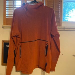 Mens Large Melanzana. Color is burnt orange.